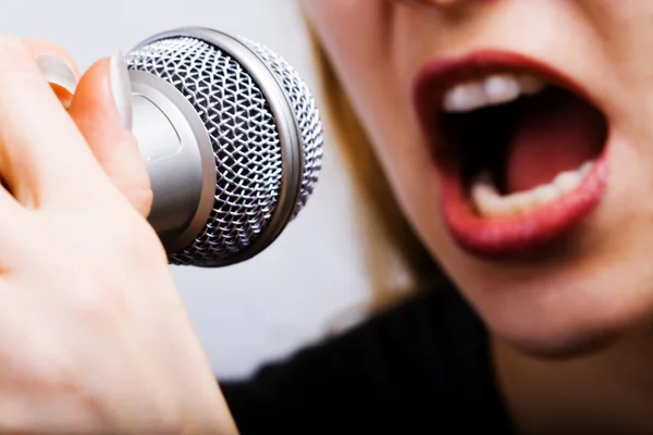 Closeup on female singer mouth and microphone — Stock Photo, Image