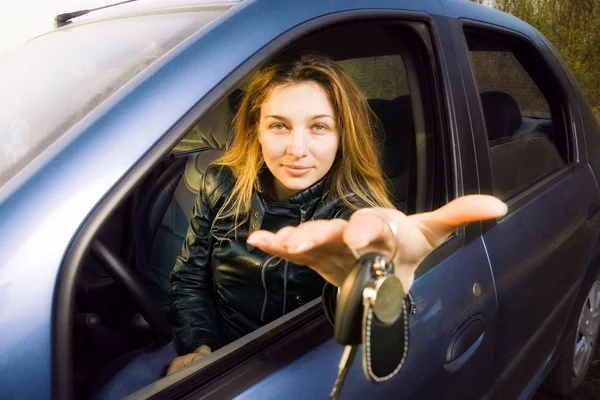 Woman offering keys to new car — Stock Photo, Image