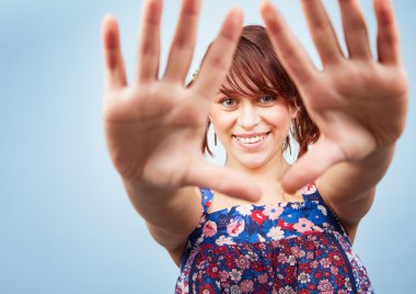 Happy playful teen woman looking through hands