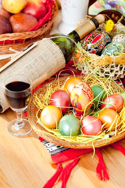 Easter painted eggs with wine bottle and glass — Stock Photo, Image