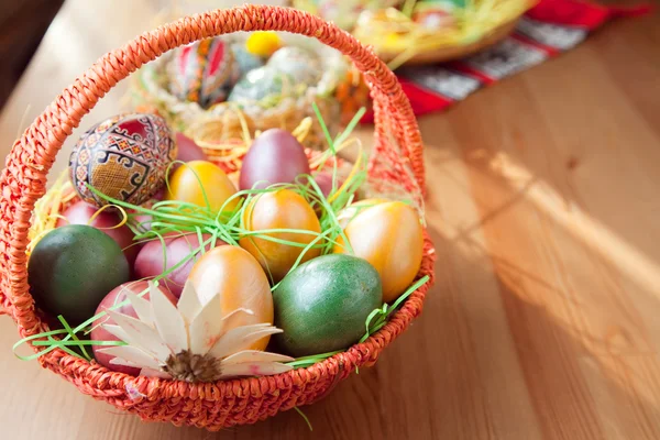 Easter painted eggs in traditional basket — Stock Photo, Image