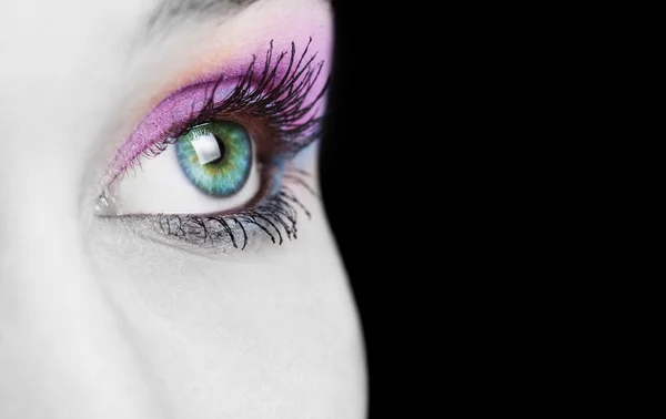 Закрыть женский глаз цветным макияжем — стоковое фото