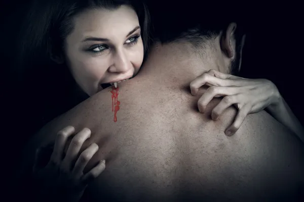 Love and blood - vampire woman biting her lover — Stock Photo, Image