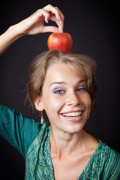 Mujer con dientes sanos y manzana en la cabeza — Foto de Stock