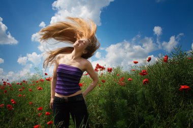 Happy joyful woman in beautiful poppy field clipart