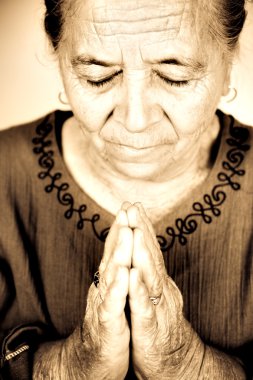 Christian senior woman praying to God clipart