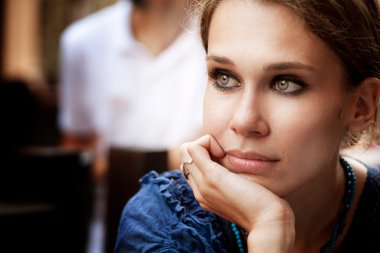 Pensive beautiful woman in the city clipart