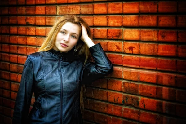 Sexy stijlvolle vrouw in leer in de buurt van muur — Stockfoto