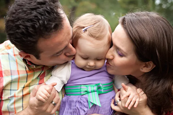 Kus van de liefde - ouders met hun babymeisje — Stockfoto