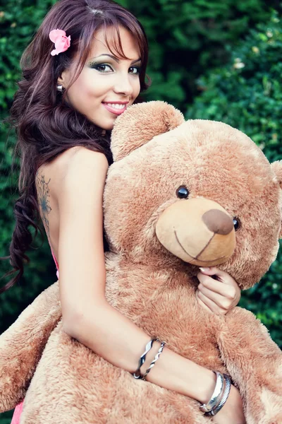 Happy cute woman and her teddy bear — Stock Photo, Image