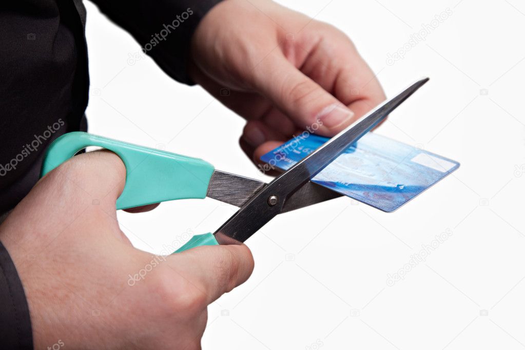 Cutting debts concept - scissors and credit card