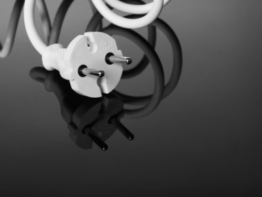 Abstract white europe standard power plug over black background. Copy-space clipart