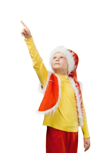 一个小男孩打扮成圣诞老人显示他的手指上东西向 — 图库照片