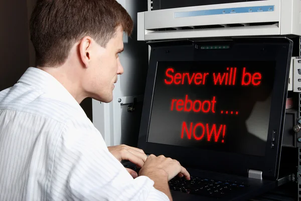 stock image The engineer stand in datacenter and configuring equipment. Server will be