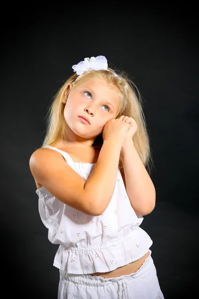Young girl posing in studio on black — Stock Photo, Image