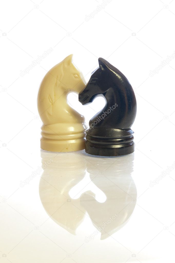 Black and white chess horses shaping a heart