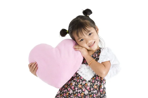 Flicka med hjärtformade kudde — Stockfoto