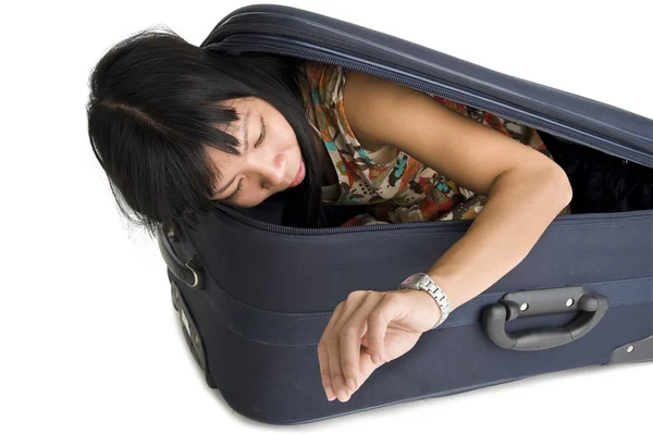 Woman in luggage checking time — Stock Photo, Image