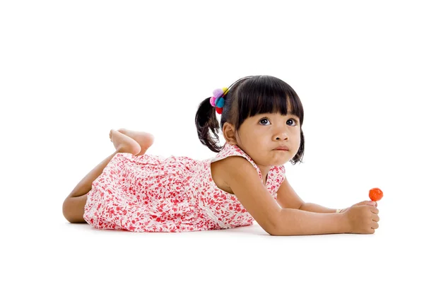 Schattig klein meisje met een lolly — Stockfoto