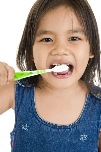 Pequeña chica asiática cepillándose los dientes — Foto de Stock