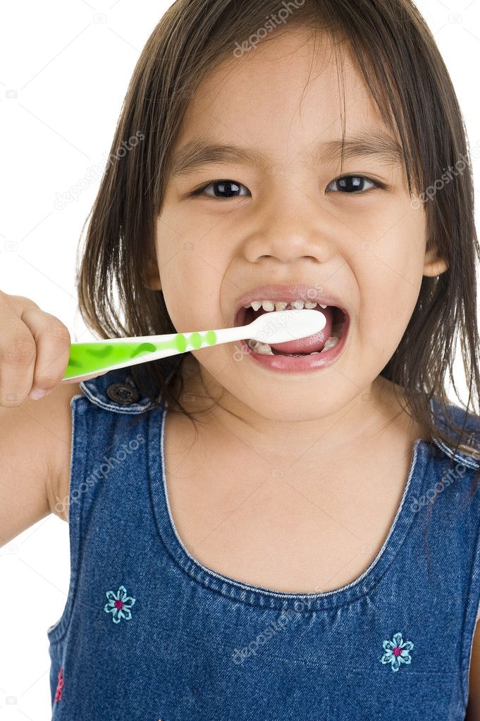 Little asian girl brushing her teeth