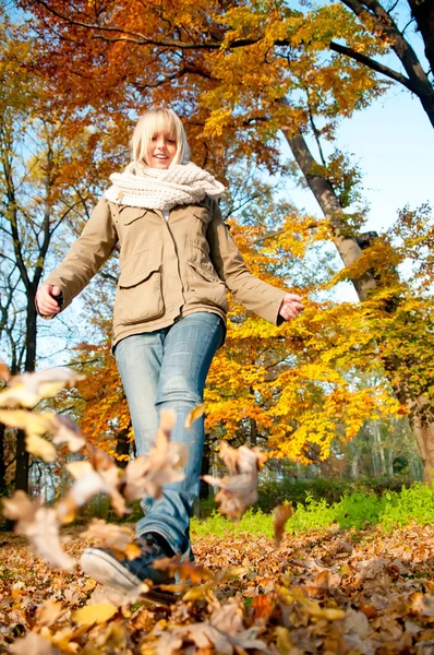Mujer jugando con hojas de otoño — Foto de Stock
