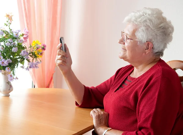 老女人与手机 免版税图库照片