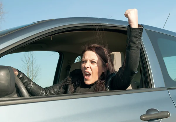 Woman in the car shows the fist — Stock Photo, Image