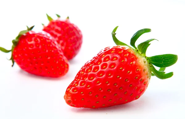 Three stawberries on the white background — Stock Photo, Image