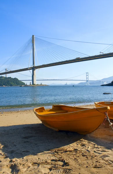 stock image Boat on the beach under the bridge