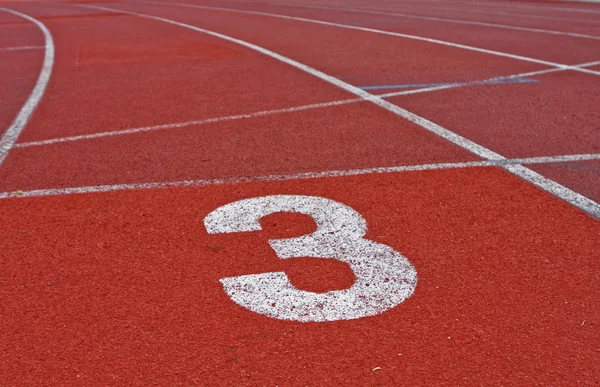 Běžecká dráha čísla jedna dvě tři stadionu — Stock fotografie