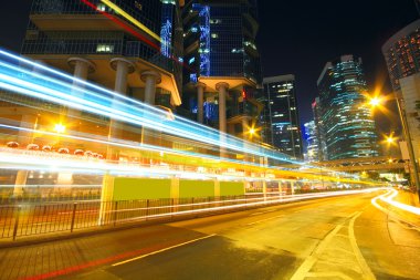 Traffic at night with traces of lights left by the cars on a hig clipart