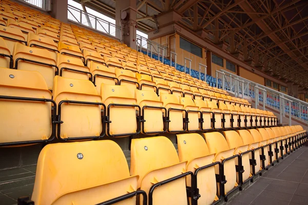 Abundância de assentos de plástico amarelo no estádio — Fotografia de Stock
