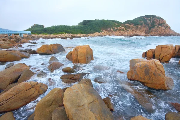 Rocky sea coast and blurred water in shek o,hong kong — Stock Photo, Image