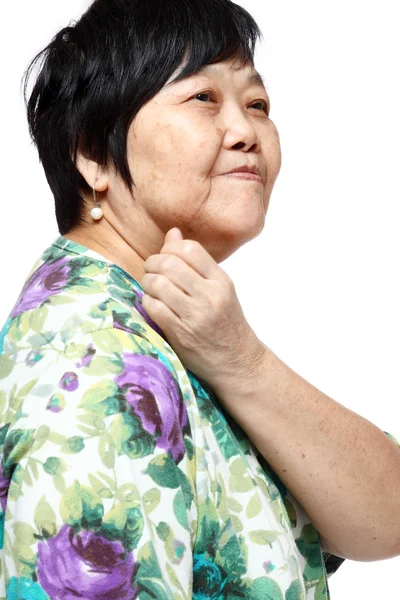 Seniorin hält ihren schmerzenden Rücken zurück — Stockfoto