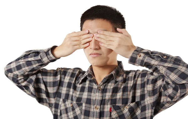 Portrait of a young man covering his eyes with hands — Stock Photo, Image