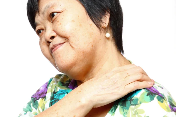 Senior woman holding her aching back — Zdjęcie stockowe