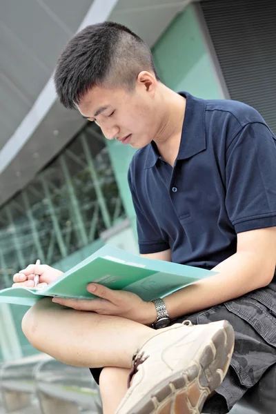 Casual asian businessman texting on his book. — Stock Photo, Image
