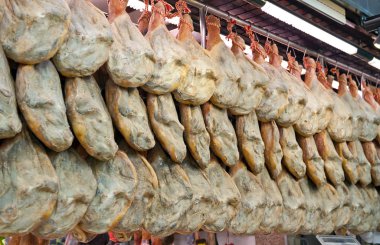 Serrano Hams hanging in the Central Market Valencia clipart