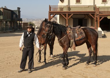 Cowboy Sheriff holding two horses clipart