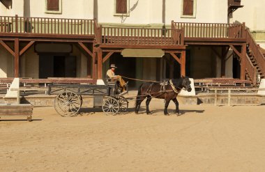 Cowboy driving a wagon at the Mini Hollywood Movie Set clipart