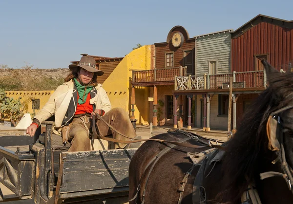Cowboy sitting on a wagon — Stock Photo, Image