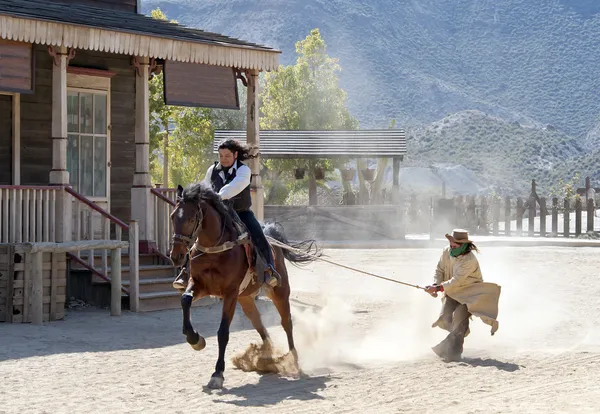 Sheriff dragging a Bandit by rope from his horse — Stock Photo, Image