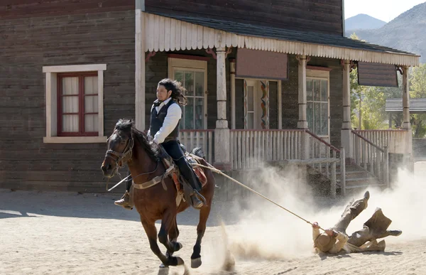 Sheriff dragging a Bandit by rope from his horse — Stock Photo, Image