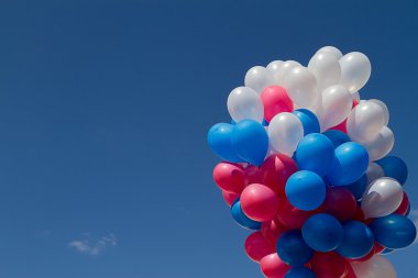 Balloons against the blue sky clipart