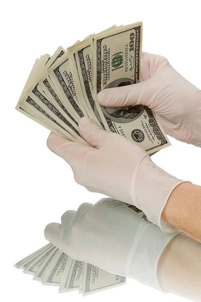 Ruce v rukavicích věří dolarů — Stock fotografie