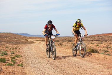 Adventure mountain bike marathon in desert clipart