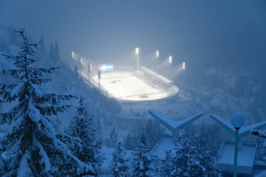 Huge ice skating rink in thick fog at sunset clipart