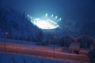 Huge ice skating rink in thick fog at sunset clipart