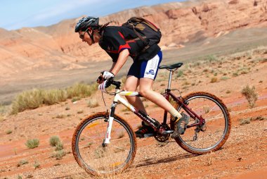 Adventure mountain bike marathon in desert clipart